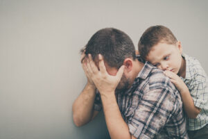 Sad Son Hugging His Dad